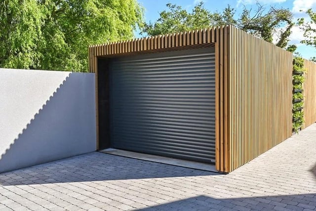 The house has off-street parking and a slatted timber garage with electric roller doors. Picture: Mishon Mackay.Mishon Mackay
