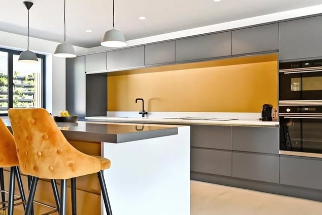 The kitchen has integrated appliances and a Corian breakfast bar. Picture: Mishon Mackay.