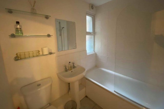 St Leonards seafront flat. The bathroom has a white low level suite with a shower above the bath. SUS-220128-113850001