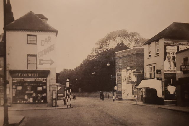 A 1940 view of Northgate, Chichester, taken by G.H. Allen. It shows a profusion of advertising hoardings.