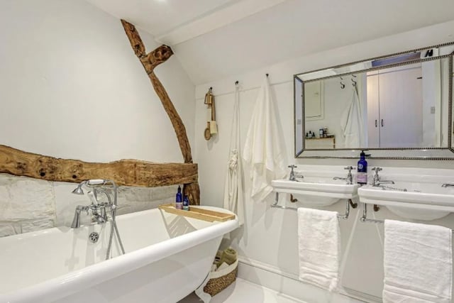 Bathroom with rolltop bath and twin washbasins