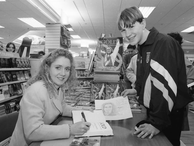 Triple Olympic gold medal winner Michelle Smith signs her book ‘Gold - A Triple Champion’s Story’ for swimming enthusiast Sean O’Boyle from Donegal when she visited Eason’s in Foyleside Shopping Centre.