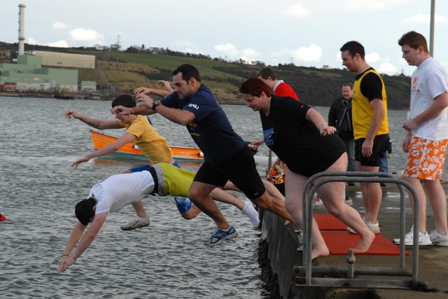 Swimmers dive into the waters of Larne Lough for the RNLI Icebreaker swim.