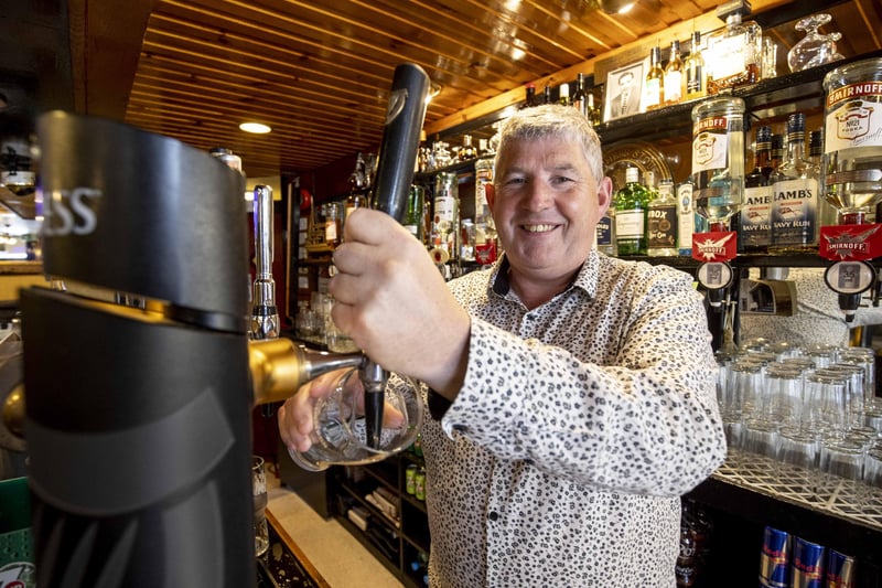 Terence O'Neill from the Queen's Arms in Coleraine pours his first pint after reopening of bars in NI today