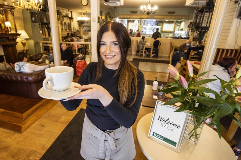 Abigail Hutchinson from Rocca in Coleraine serves coffee as indoor dining opens in NI today