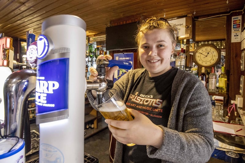 Kirsty Thompson at Mary Craigs Bar in Coleraine pours the first pint after reopening of bars in NI today