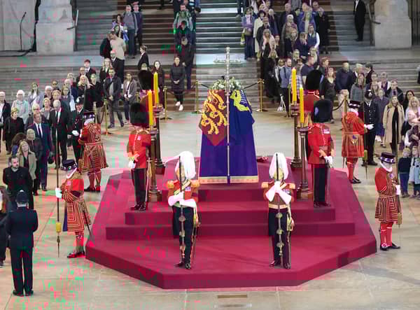 Members of the public file past the coffin of Queen Elizabeth II, draped in the Royal Standard with the Imperial State Crown and the Sovereign's orb and sceptre, lying in state on the catafalque in Westminster Hall, at the Palace of Westminster, London, ahead of her funeral on Monday. Picture: Yui Mok/PA Wire