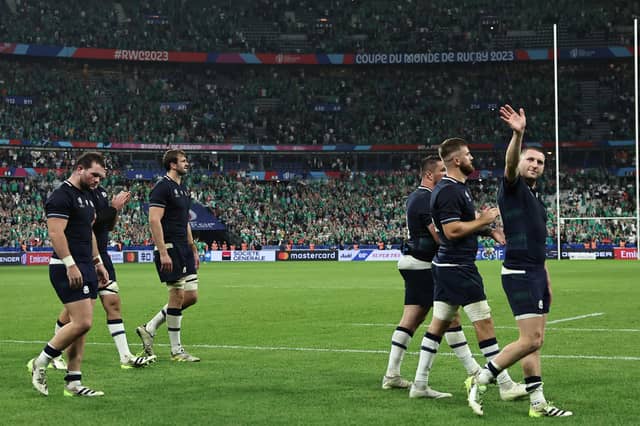 Scotland's Finn Russell, right, acknowledges the supporters after the defeat by Ireland in the Stade de France. (Photo by FRANCK FIFE/AFP via Getty Images)