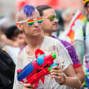 A man cools down spectators with his water gun as he marches in the Pride Parade in Toronto, Canada. The Canadian government has warned citizens travelling to the US that some states have passed laws which could cause issues for LGBTQ+ people.