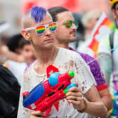 A man cools down spectators with his water gun as he marches in the Pride Parade in Toronto, Canada. The Canadian government has warned citizens travelling to the US that some states have passed laws which could cause issues for LGBTQ+ people.