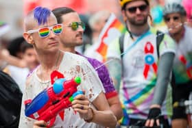A man cools down spectators with his water gun as he marches in the Pride Parade in Toronto, Canada. The Canadian government has warned citizens travelling to the US that some states have passed laws which could cause issues for LGBTQ+ people.