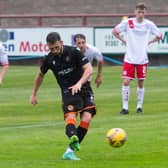 Dundee United's Nicky Clark completes his hat-trick from the penalty spot.