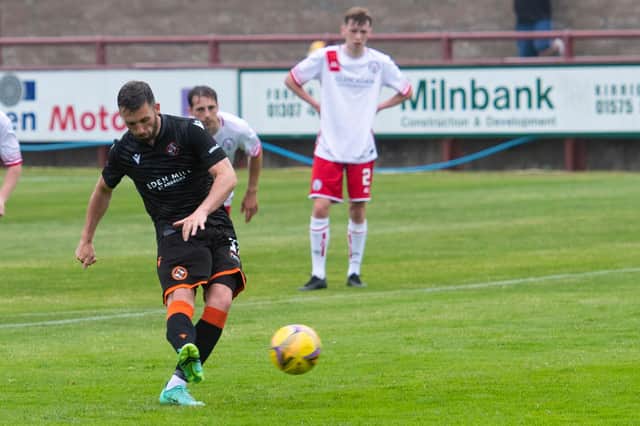 Dundee United's Nicky Clark completes his hat-trick from the penalty spot.