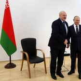Russia's President Vladimir Putin (R) shakes hands with Belarus President Alexander Lukashenko in April.