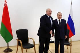 Russia's President Vladimir Putin (R) shakes hands with Belarus President Alexander Lukashenko in April.