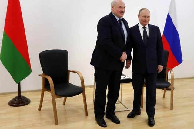 Russia's President Vladimir Putin (R) shakes hands with Belarus President Alexander Lukashenko in April.