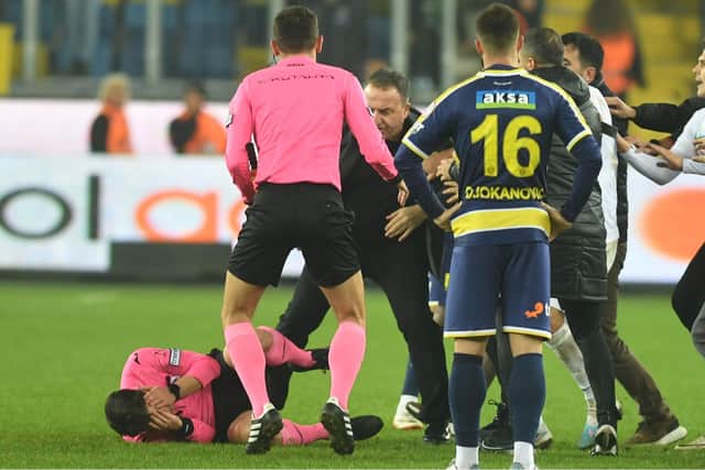 Match referee Halil Umut Meler was assaulted following the Turkish Super Lig clash between Ankaragucu vs. Rizespor in Ankara, Turkey, on 12 December 2023. At the end of the match, Ankaragucu club president Faruk Koca (centre) punched referee Halil Umut Meler in the face. The referee fell to the ground and was kicked by people entering the field. Photo by Abdurrahman Antakyali/Depo Photos via ZUMA Press Wire/Shutterstock (14253645d)
