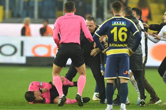 Match referee Halil Umut Meler was assaulted following the Turkish Super Lig clash between Ankaragucu vs. Rizespor in Ankara, Turkey, on 12 December 2023. At the end of the match, Ankaragucu club president Faruk Koca (centre) punched referee Halil Umut Meler in the face. The referee fell to the ground and was kicked by people entering the field. Photo by Abdurrahman Antakyali/Depo Photos via ZUMA Press Wire/Shutterstock (14253645d)
