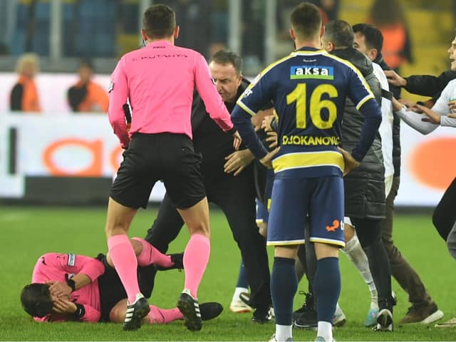 Match referee Halil Umut Meler was assaulted following the Turkish Super Lig clash between Ankaragucu vs. Rizespor in Ankara, Turkey, on 12 December 2023. At the end of the match, Ankaragucu club president Faruk Koca (centre) punched referee Halil Umut Meler in the face. The referee fell to the ground and was kicked by people entering the field. Photo by Abdurrahman Antakyali/Depo Photos via ZUMA Press Wire/Shutterstock (14253645d)