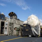 US sailors with material recovered off the coast of South Carolina following the shooting down of a Chinese high-altitude balloon (Picture: Ryan Seelbach/US Navy via AP)