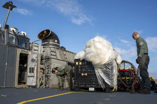US sailors with material recovered off the coast of South Carolina following the shooting down of a Chinese high-altitude balloon (Picture: Ryan Seelbach/US Navy via AP)