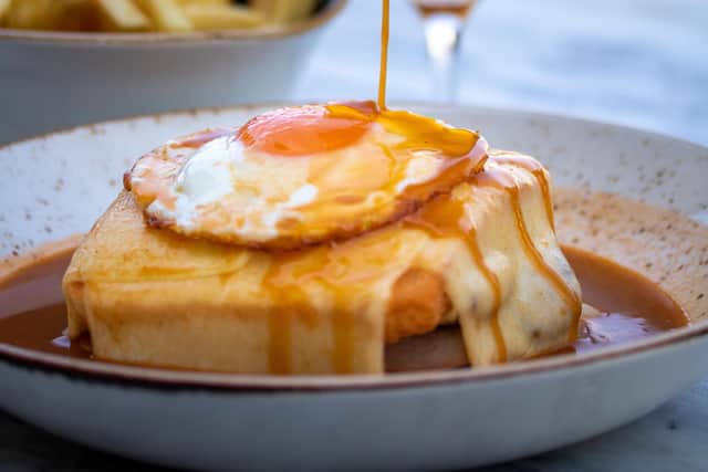 The francesinha (veggie option available), a toasted meat sandwich topped with a fried egg and melted cheese in a tomato-and-beer sauce, a Porto speciality served at  T&C restaurant, WOW, Porto. Pic: Contributed