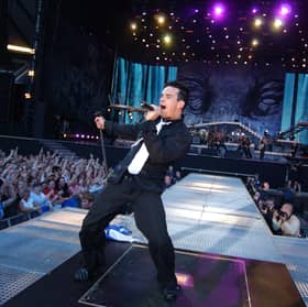 Robbie Williams takes to the stage at BST Hyde Park this weekend (July 6), but will the weather hold out for the “Angels” singer? (Credit: Getty Images)
