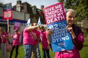 Campaigners in support of assisted dying gather outside the Houses of Parliament in 2015