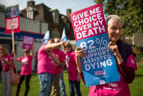 Campaigners in support of assisted dying gather outside the Houses of Parliament in 2015