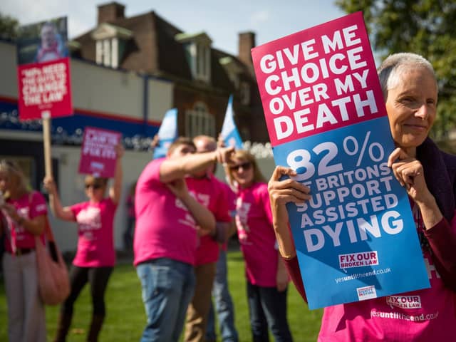 Campaigners in support of assisted dying gather outside the Houses of Parliament in 2015
