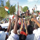 People carry on their shoulders Othman Mohamed, a senior general loyal to army chief Abdel Fattah al-Burhan, in the Red Sea city of Port Sudan, last week. British diplomats and their families have been evacuated from the country.