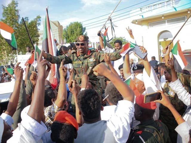 People carry on their shoulders Othman Mohamed, a senior general loyal to army chief Abdel Fattah al-Burhan, in the Red Sea city of Port Sudan, last week. British diplomats and their families have been evacuated from the country.