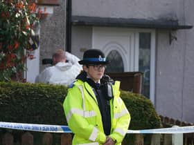 Police and forensic investigators outside the house in St Helens