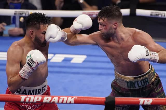 Josh Taylor hits Jose Ramirez, left, during a junior welterweight title boxing bout Saturday, May 22, 2021, in Las Vegas.