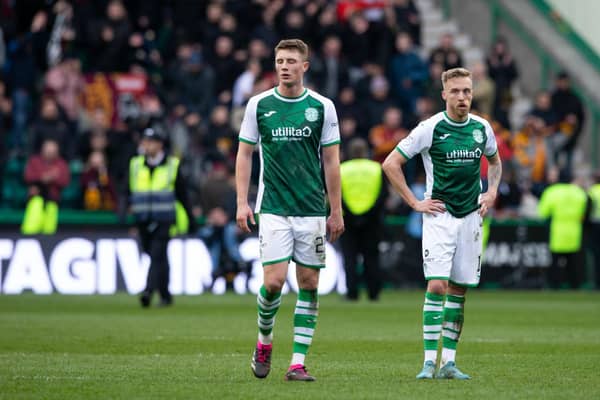 Hibs duo James Jeggo, right, and Will Fish show their dejection at full time against Motherwell.