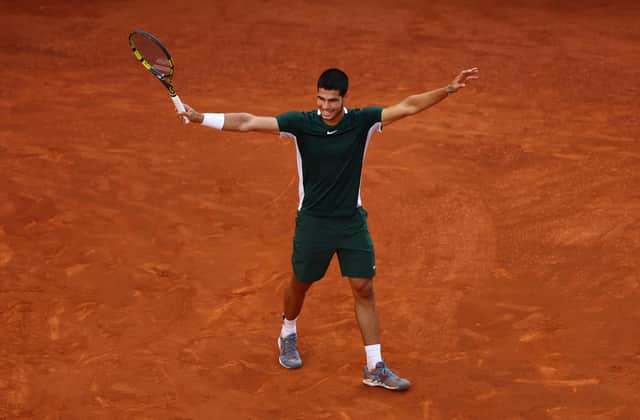 Carlos Alcaraz of Spain celebrates match point during the Men's Singles final match against Alexander Zverev of Germany during day eleven of Mutua Madrid Open at La Caja Magica on May 08, 2022 in Madrid, Spain (Photo by Clive Brunskill/Getty Images)