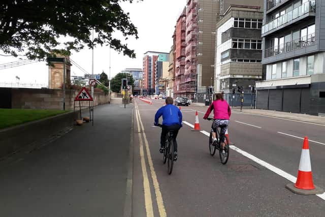 Cyclists using a new bike lane on Clyde Street in Glasgow city centre.