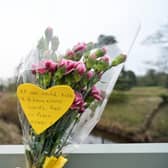 Flowers and a message tied to a bridge over the River Wyre in St Michael's on Wyre, Lancashire, after police announced that the body recovered from the River Wyre on Sunday, was that of Nicola Bulley, who disappeared on January 27. Picture date: Tuesday February 21, 2023.