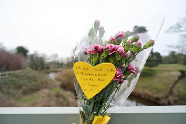 Flowers and a message tied to a bridge over the River Wyre in St Michael's on Wyre, Lancashire, after police announced that the body recovered from the River Wyre on Sunday, was that of Nicola Bulley, who disappeared on January 27. Picture date: Tuesday February 21, 2023.