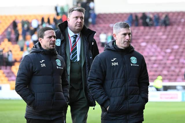 Hibs manager Nick Montgomery and his assistant Sergio Raimundo leave the pitch.