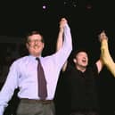 U2's lead singer Bono holds up the arms of Ulster Unionist leader David Trimble, left, and SDLP leader John Hume at a concert to promote the Good Friday Agreement (Picture: Gerry Penny/AFP via Getty Images)