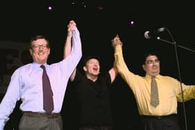 U2's lead singer Bono holds up the arms of Ulster Unionist leader David Trimble, left, and SDLP leader John Hume at a concert to promote the Good Friday Agreement (Picture: Gerry Penny/AFP via Getty Images)