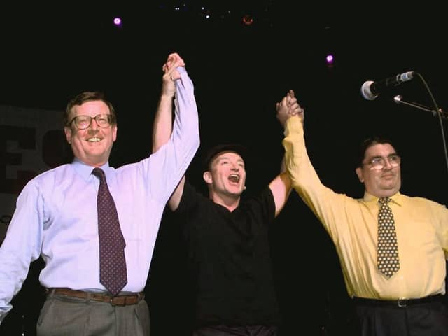 U2's lead singer Bono holds up the arms of Ulster Unionist leader David Trimble, left, and SDLP leader John Hume at a concert to promote the Good Friday Agreement (Picture: Gerry Penny/AFP via Getty Images)