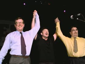 U2's lead singer Bono holds up the arms of Ulster Unionist leader David Trimble, left, and SDLP leader John Hume at a concert to promote the Good Friday Agreement (Picture: Gerry Penny/AFP via Getty Images)