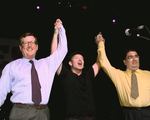 U2's lead singer Bono holds up the arms of Ulster Unionist leader David Trimble, left, and SDLP leader John Hume at a concert to promote the Good Friday Agreement (Picture: Gerry Penny/AFP via Getty Images)