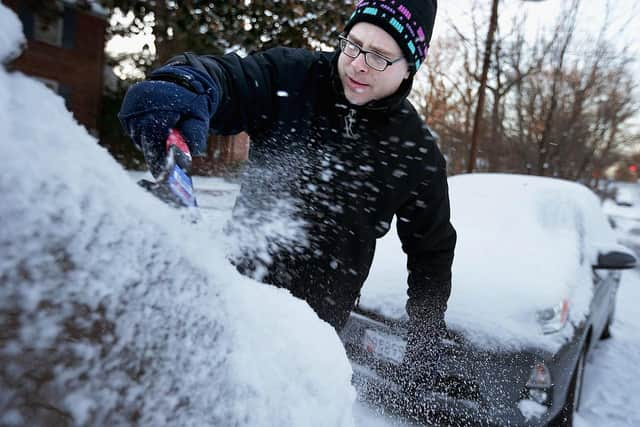 A plastic scraper should only be used to remove chunks of ice that are already thawed; it can scratch the glass if enough force is used (Photo: Chip Somodevilla/Getty Images)