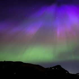 The aurora borealis, also known as the northern lights, above Arthur’s Seat and Salisbury Crags in Holyrood Park, Edinburgh in May. 
