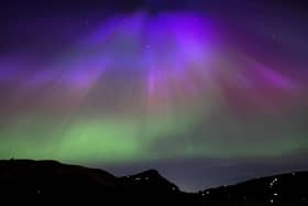 The aurora borealis, also known as the northern lights, above Arthur’s Seat and Salisbury Crags in Holyrood Park, Edinburgh in May. 