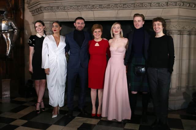 Izuka Hoyle with the cast of Mary Queen of Scots. Lleft to right, Eileen O'Higgins, Izuka Hoyle, James McArdle, First Minister Nicola Sturgeon, Saoirse Ronan, Jack Lowden and actress Karen Dunbar at the Scottish premiere of the film at Edinburgh Castle. Pic: PA