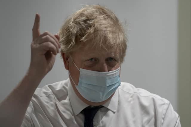 Prime Minister Boris Johnson gestures during a visit to the New Queen Elizabeth II Hospital, Welwyn Garden City, Hertfordshire.